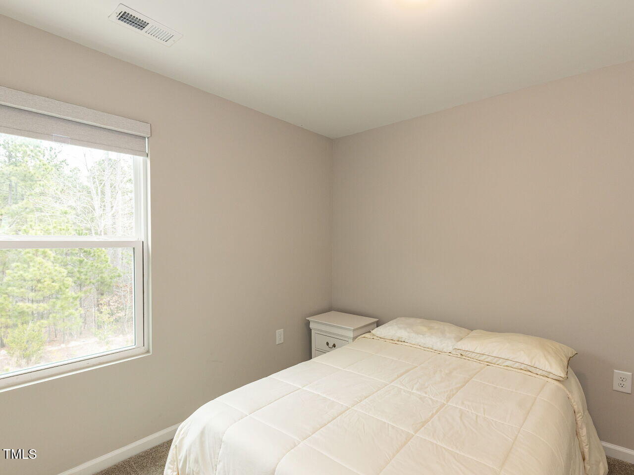 730 Firebrick Drive Cary, NC 27519 - Photo 26 of 38 a bedroom with a bed and a window