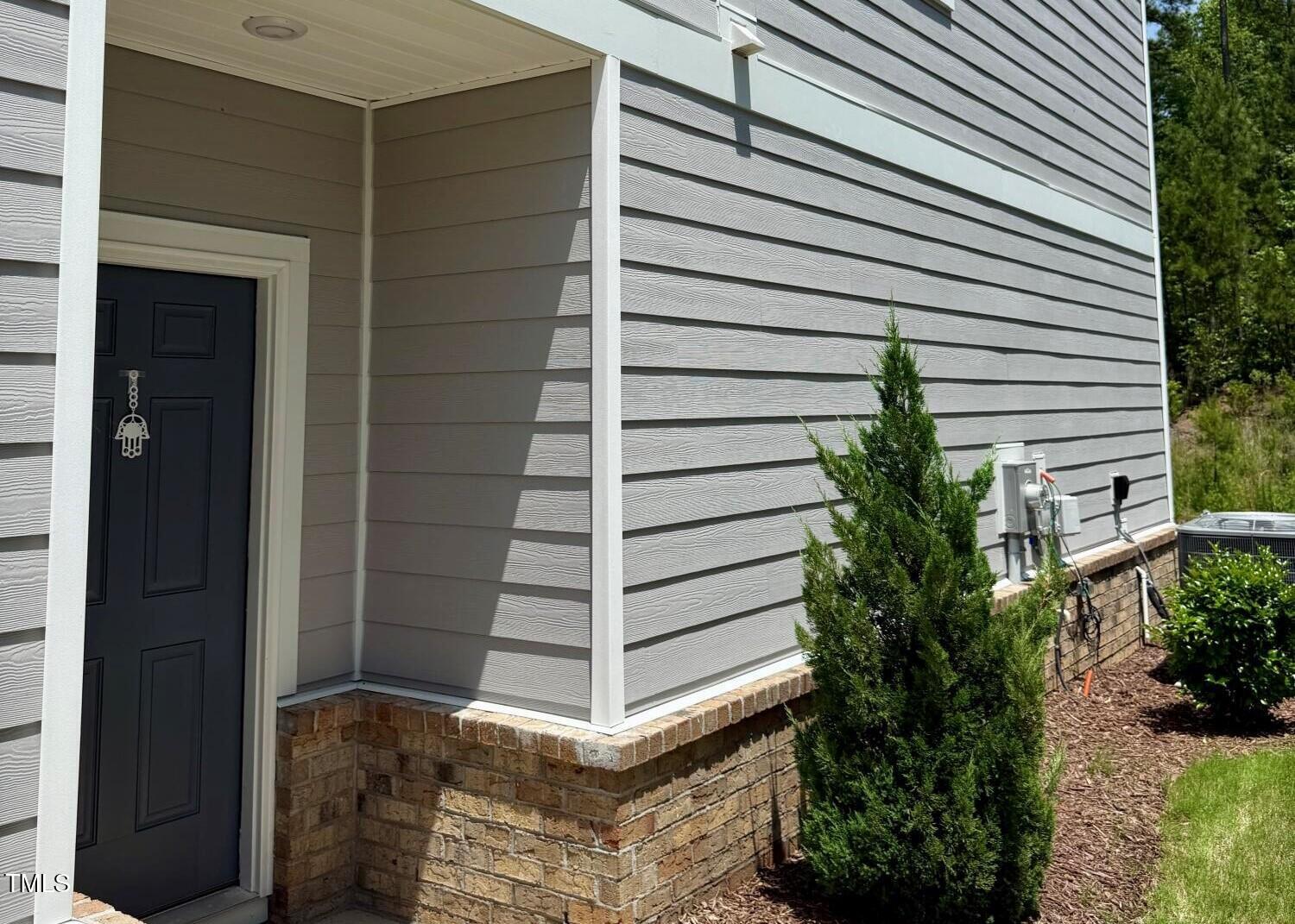 730 Firebrick Drive Cary, NC 27519 - Photo 3 of 38 a view of potted plants in front of door