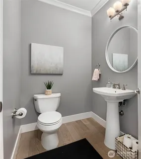 a bathroom with a sink toilet and a mirror