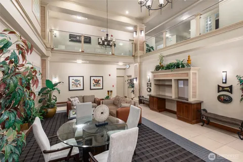 a living room with furniture kitchen view and a fireplace