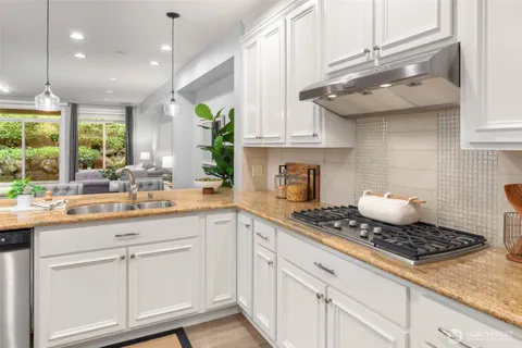 a kitchen with kitchen island white cabinets and white appliances