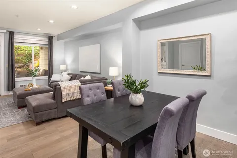 a dining room with furniture and wooden floor