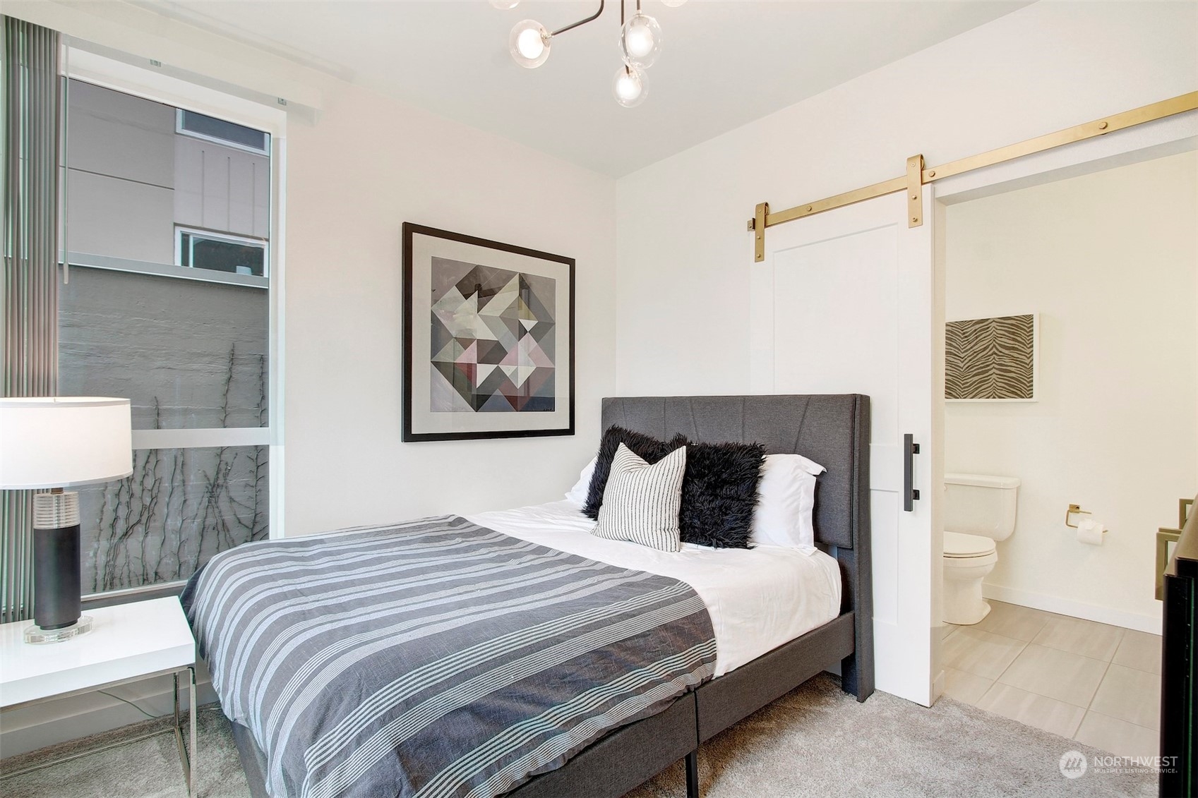 1213 East Mercer Street Seattle, WA 98102 - Photo 14 of 29 a bedroom with a large bed and a painting on the wall