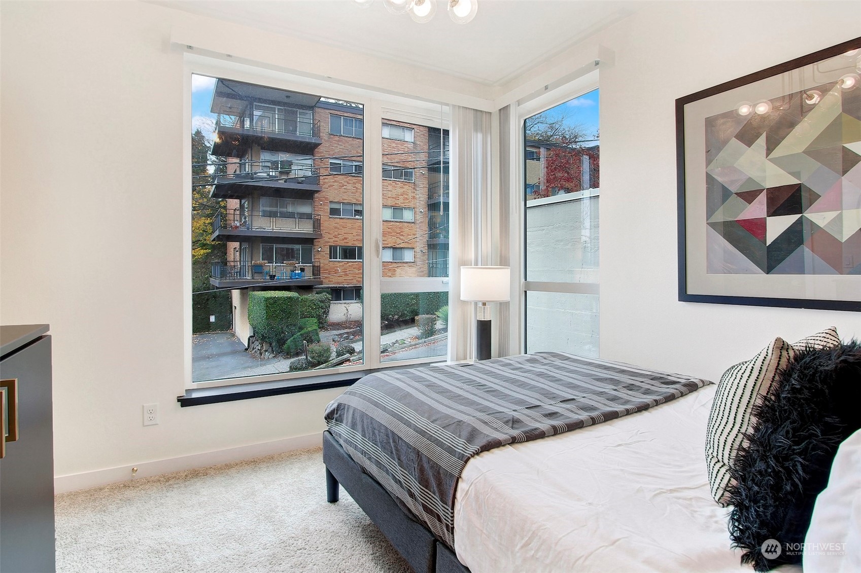 1213 East Mercer Street Seattle, WA 98102 - Photo 15 of 29 a bed sitting in a bedroom next to a window