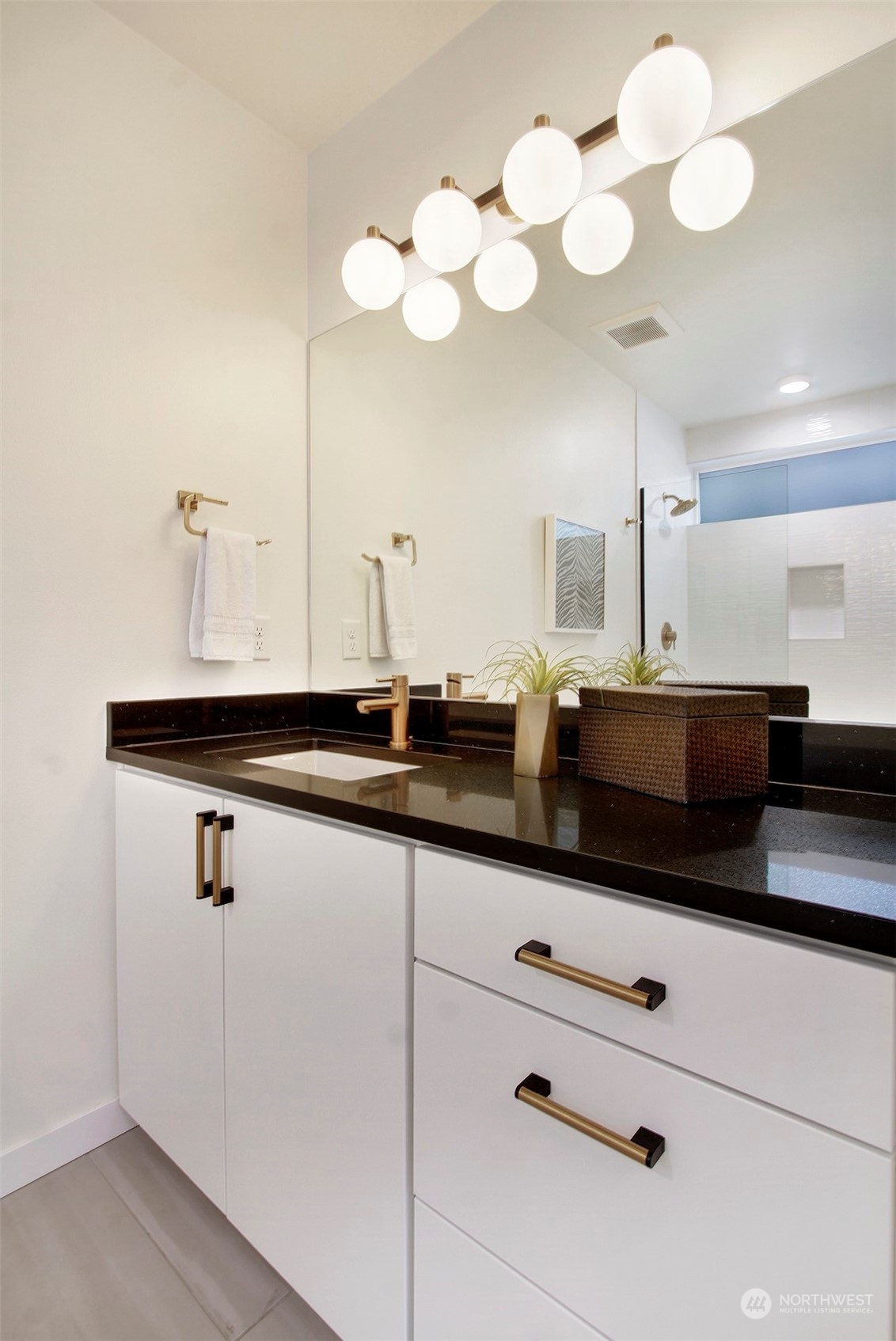 1213 East Mercer Street Seattle, WA 98102 - Photo 17 of 29 a bathroom with a sink vanity and a mirror