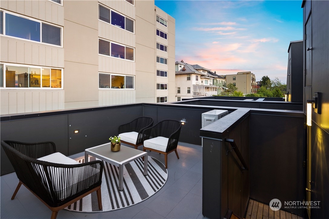 1213 East Mercer Street Seattle, WA 98102 - Photo 20 of 29 a view of a balcony with table and chairs