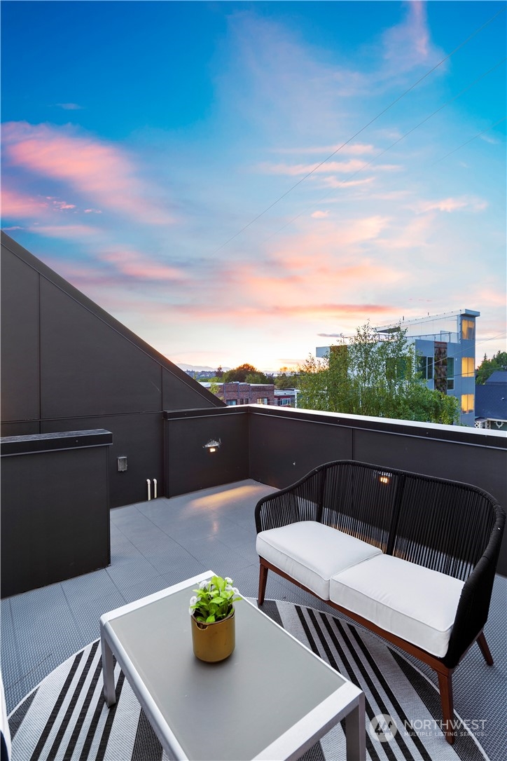 1213 East Mercer Street Seattle, WA 98102 - Photo 21 of 29 a terrace with outdoor seating and city view