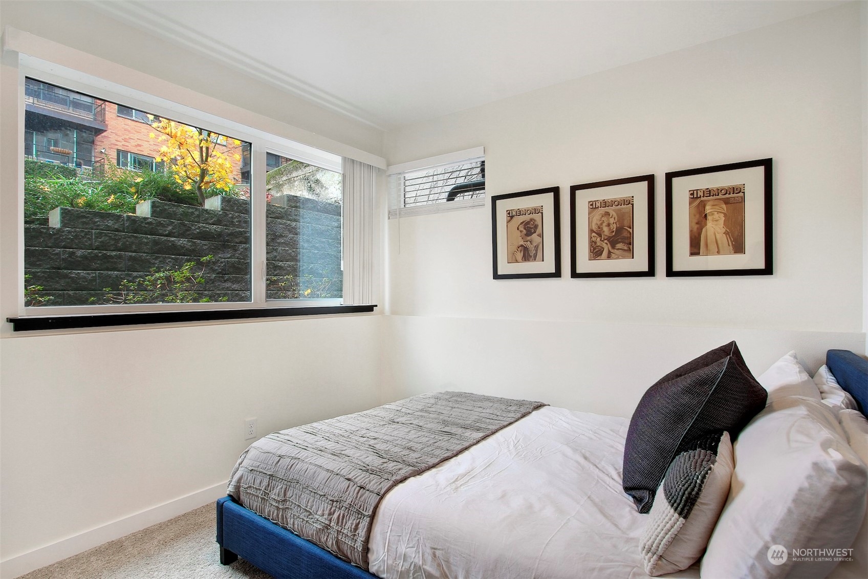 1213 East Mercer Street Seattle, WA 98102 - Photo 3 of 29 a bedroom with a bed and a window