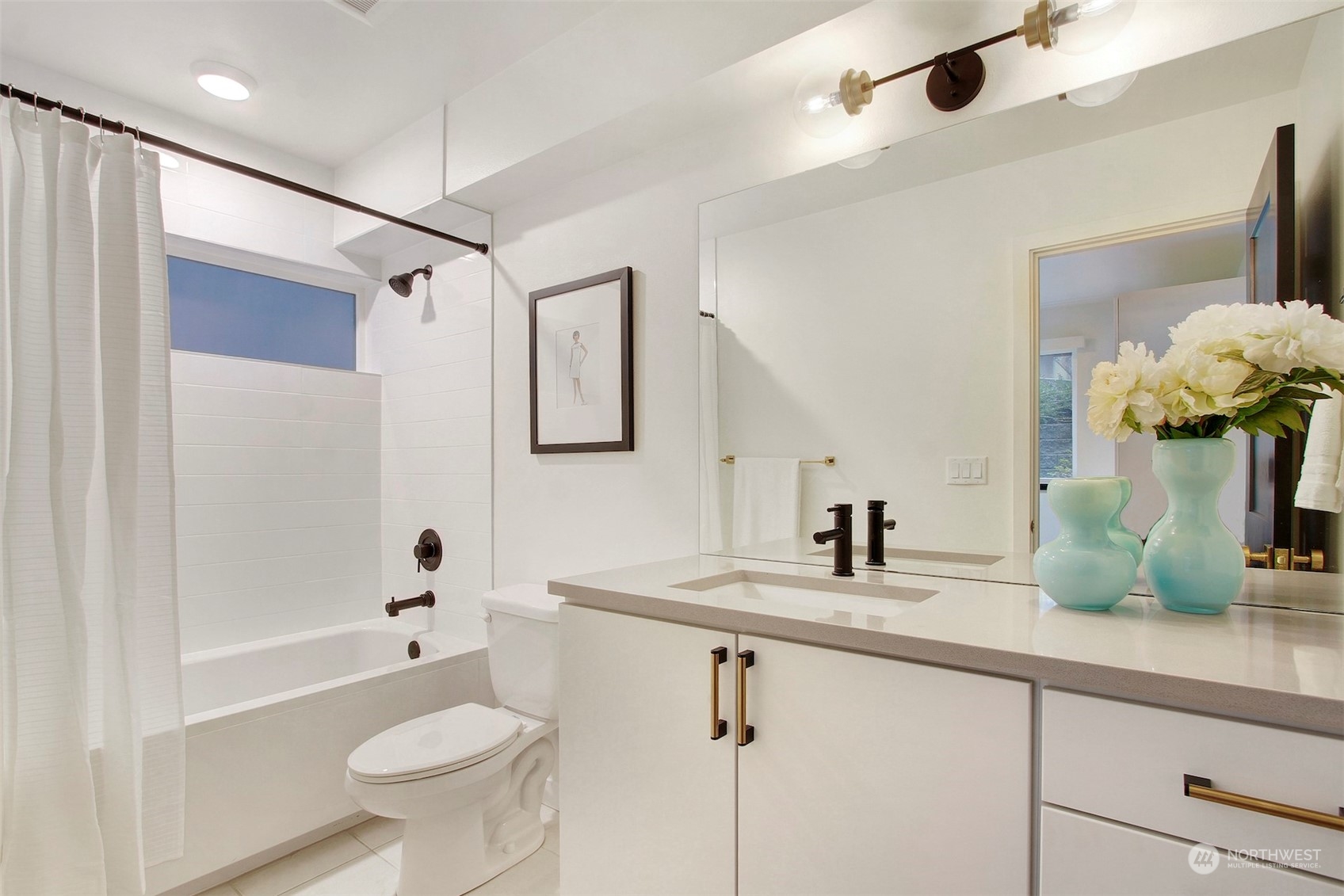 1213 East Mercer Street Seattle, WA 98102 - Photo 4 of 29 a bathroom with a double vanity sink toilet mirror and bathtub