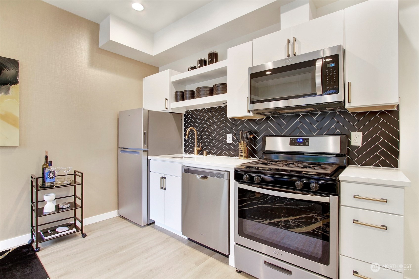1213 East Mercer Street Seattle, WA 98102 - Photo 9 of 29 a kitchen with a stove and a microwave