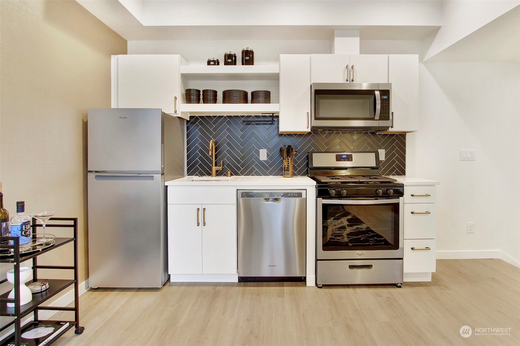 1213 East Mercer Street Seattle, WA 98102 - Photo 10 of 29 a kitchen with stainless steel appliances a stove a microwave and a refrigerator