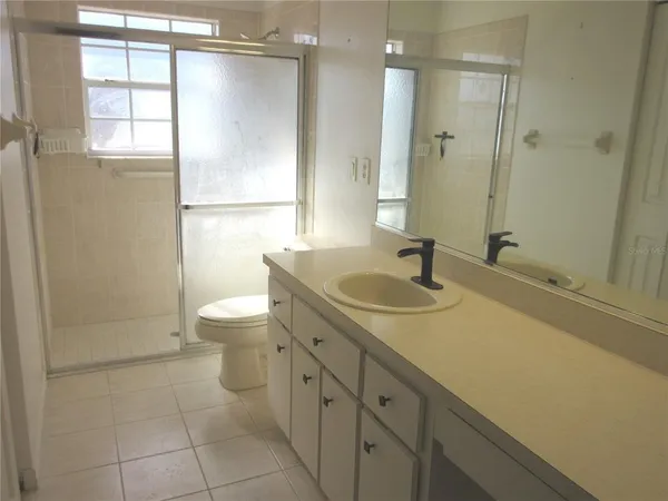 a bathroom with a sink toilet a shower and a mirror