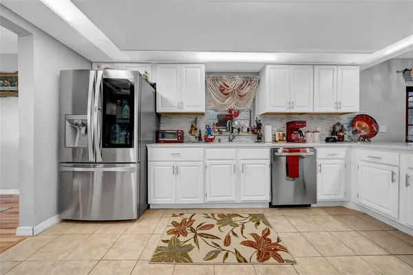 a living room with furniture a fireplace and a large window