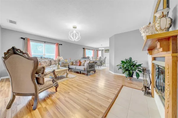 a living room with a painting on the wall and a fireplace