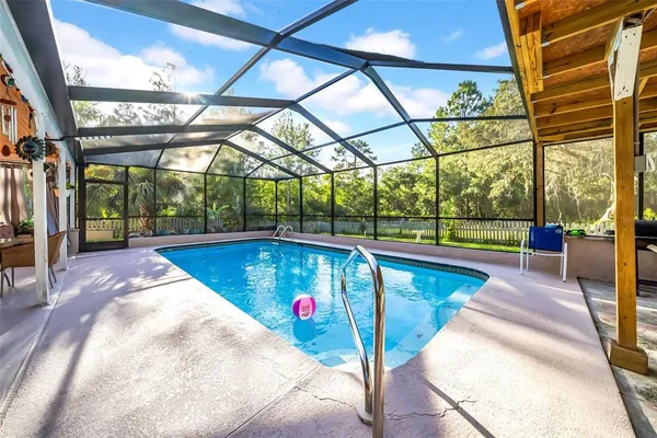 a view of a swimming pool with a patio