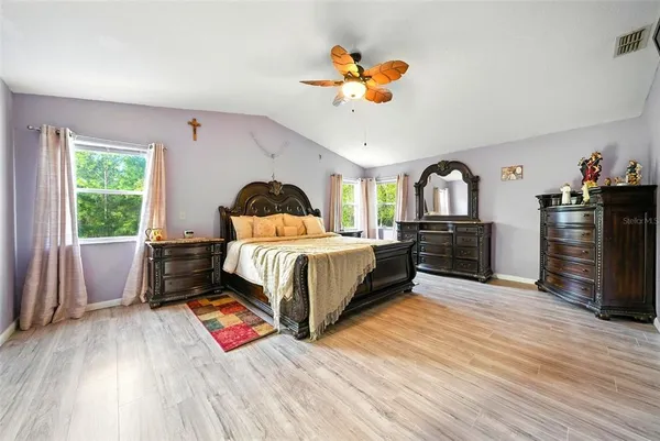 a view of a hallway with wooden floor and a rug