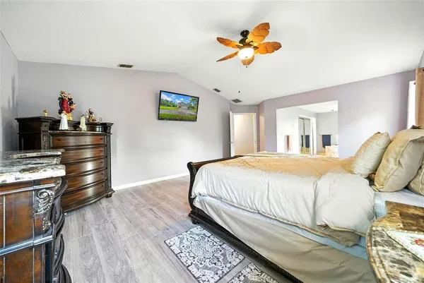 a bedroom with a bed and a flat screen tv