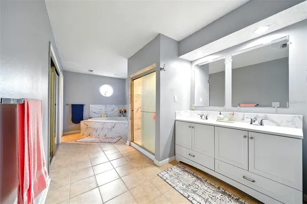 a bedroom with bed and wooden floor