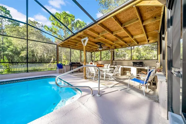 a view of a house with a yard and sitting area