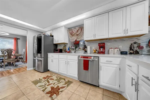 a kitchen with stainless steel appliances granite countertop a stove and a refrigerator