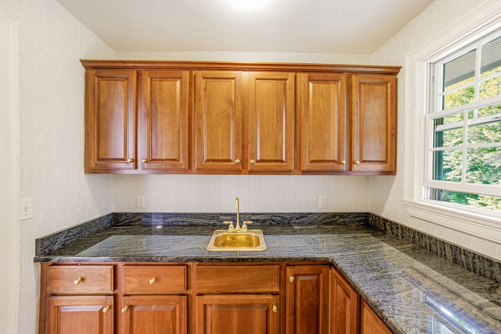 85 Cedarwood Road Boxborough, MA 01719 - Photo 19 of 41 a kitchen with granite countertop cabinets sink and window