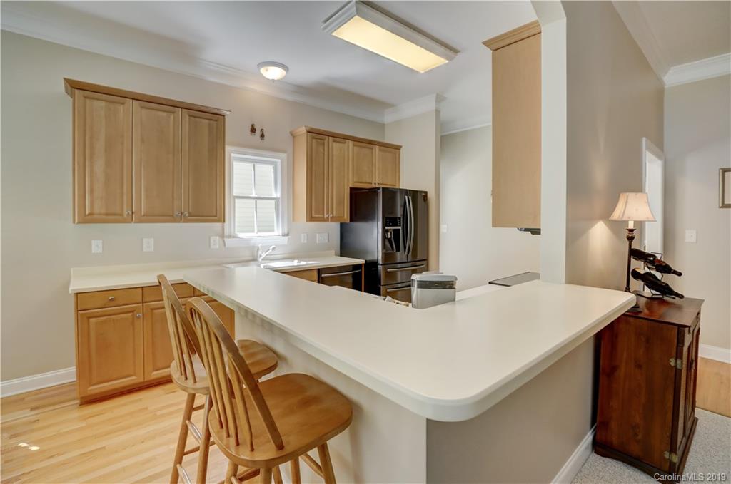 779 Julia Street Fort Mill, SC 29708 - Photo 18 of 48 a kitchen with a table chairs and a refrigerator
