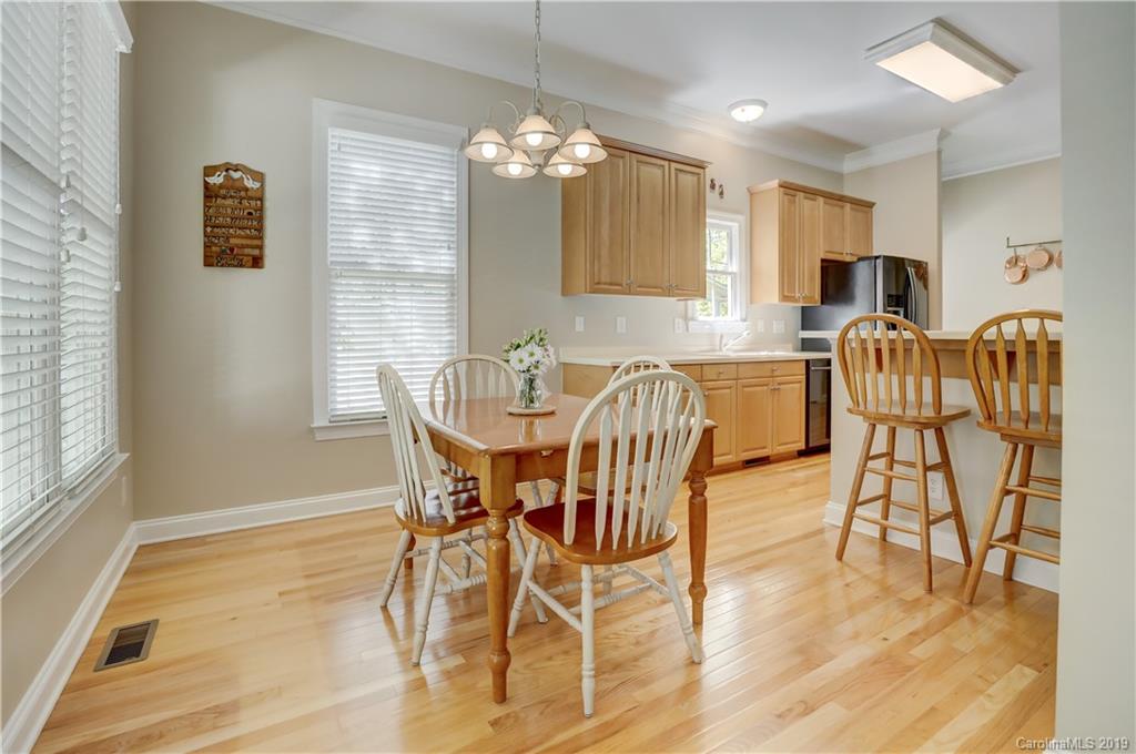 779 Julia Street Fort Mill, SC 29708 - Photo 19 of 48 a view of a dining room with furniture and wooden floor