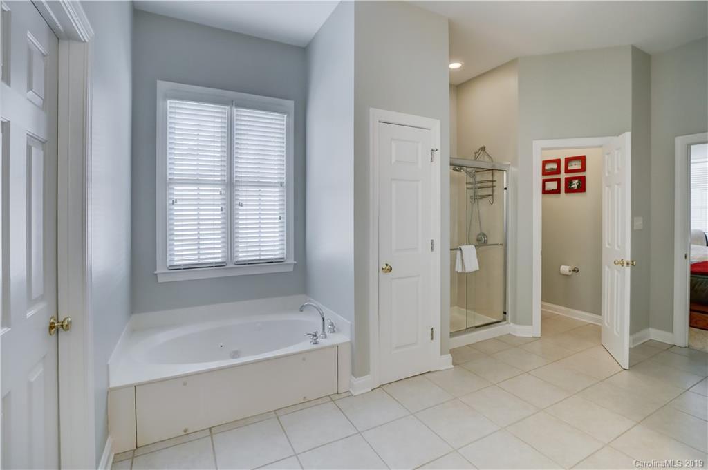 779 Julia Street Fort Mill, SC 29708 - Photo 25 of 48 a spacious bathroom with a bathtub and shower