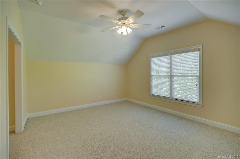 779 Julia Street Fort Mill, SC 29708 - Photo 34 of 48 an empty room with a window and a ceiling fan