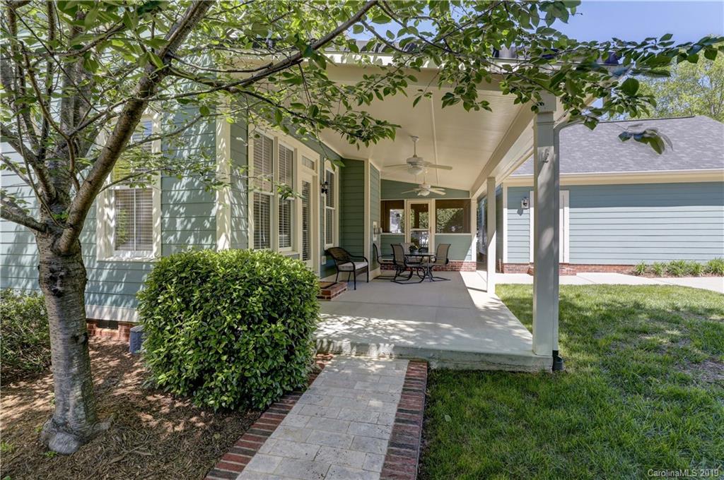 779 Julia Street Fort Mill, SC 29708 - Photo 45 of 48 a view of a patio with table and chairs potted plants and large tree