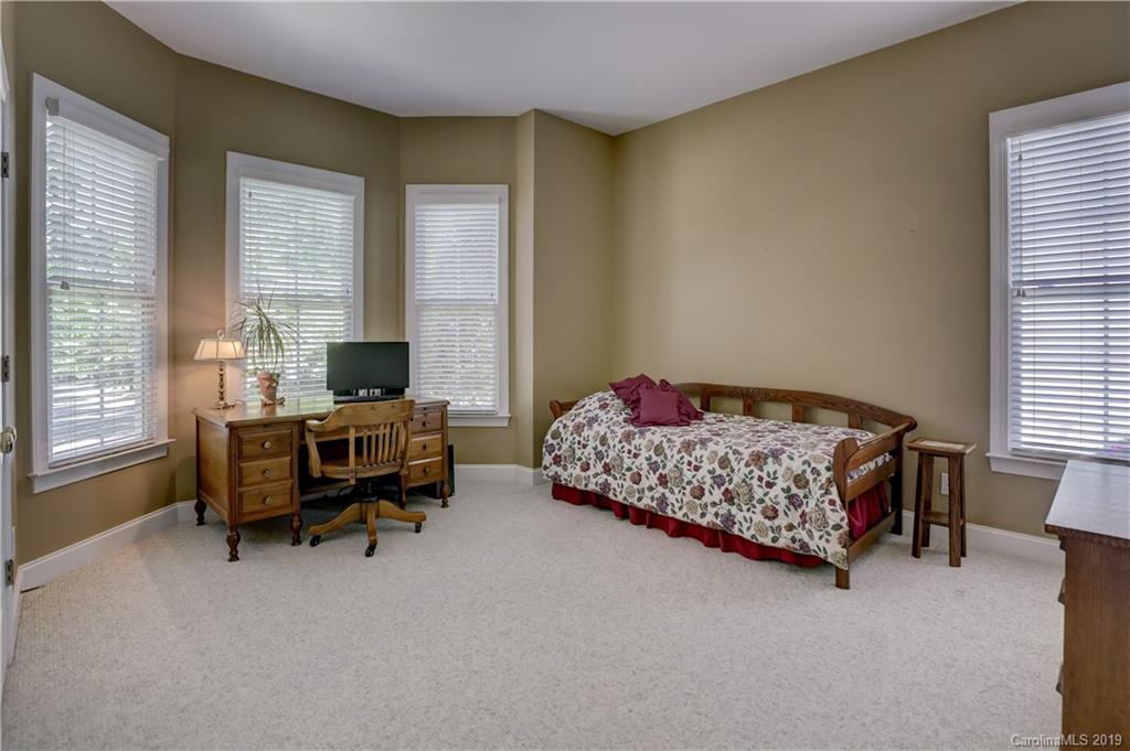 779 Julia Street Fort Mill, SC 29708 - Photo 9 of 48 a bedroom with a bed and a desk