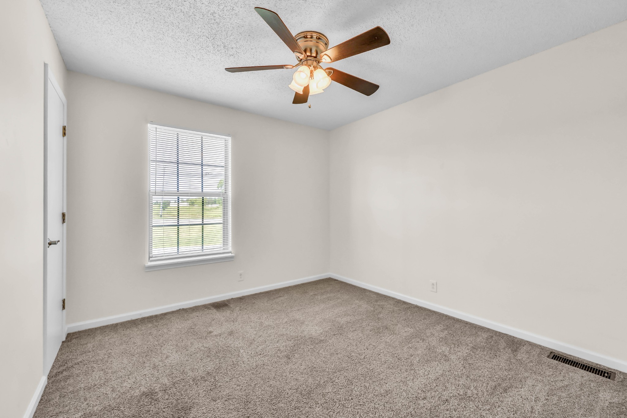 2451 Wilson Road, Unit 6 Clarksville, TN 37043 - Photo 14 of 21 an empty room with windows and fan