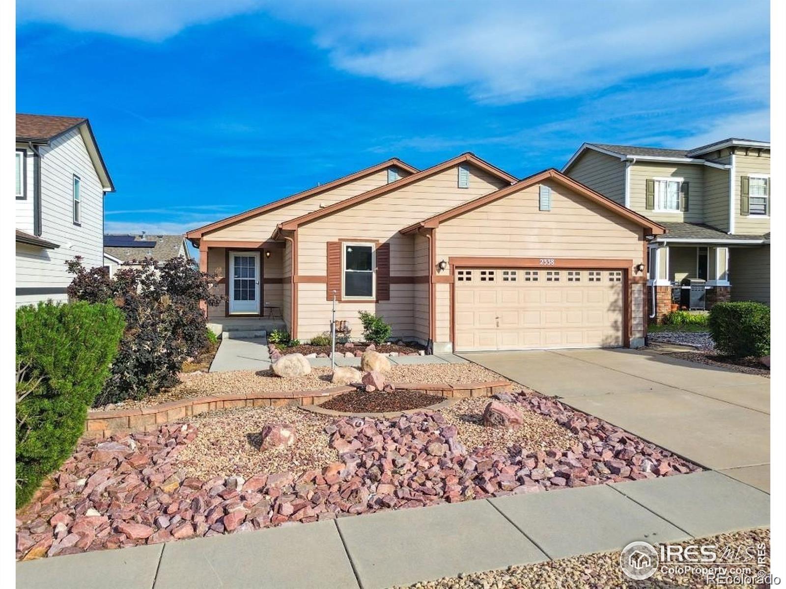 2338 Jeanette Way Colorado Springs, CO 80951 - Photo 2 of 18 a front view of a house with a garden