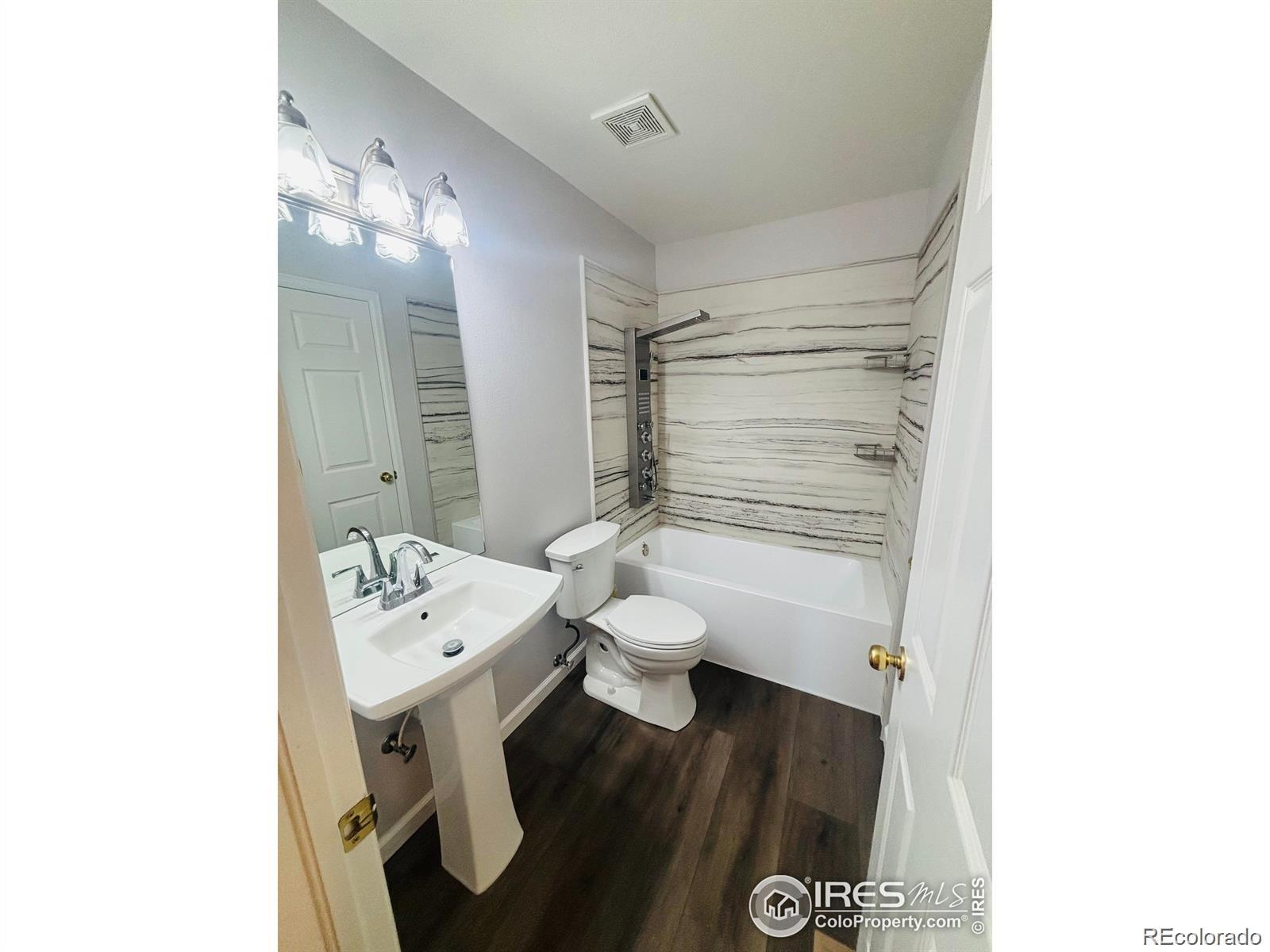 2338 Jeanette Way Colorado Springs, CO 80951 - Photo 7 of 18 a bathroom with a sink toilet and mirror