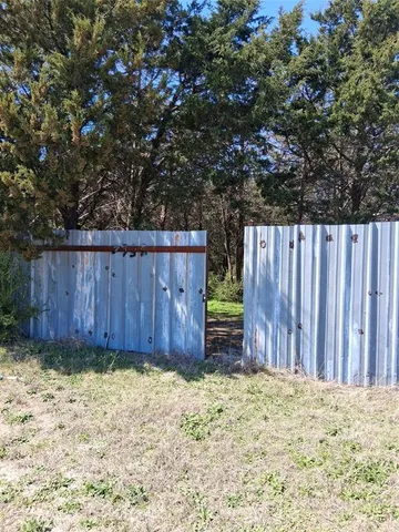 a view of outdoor space and wooden fence