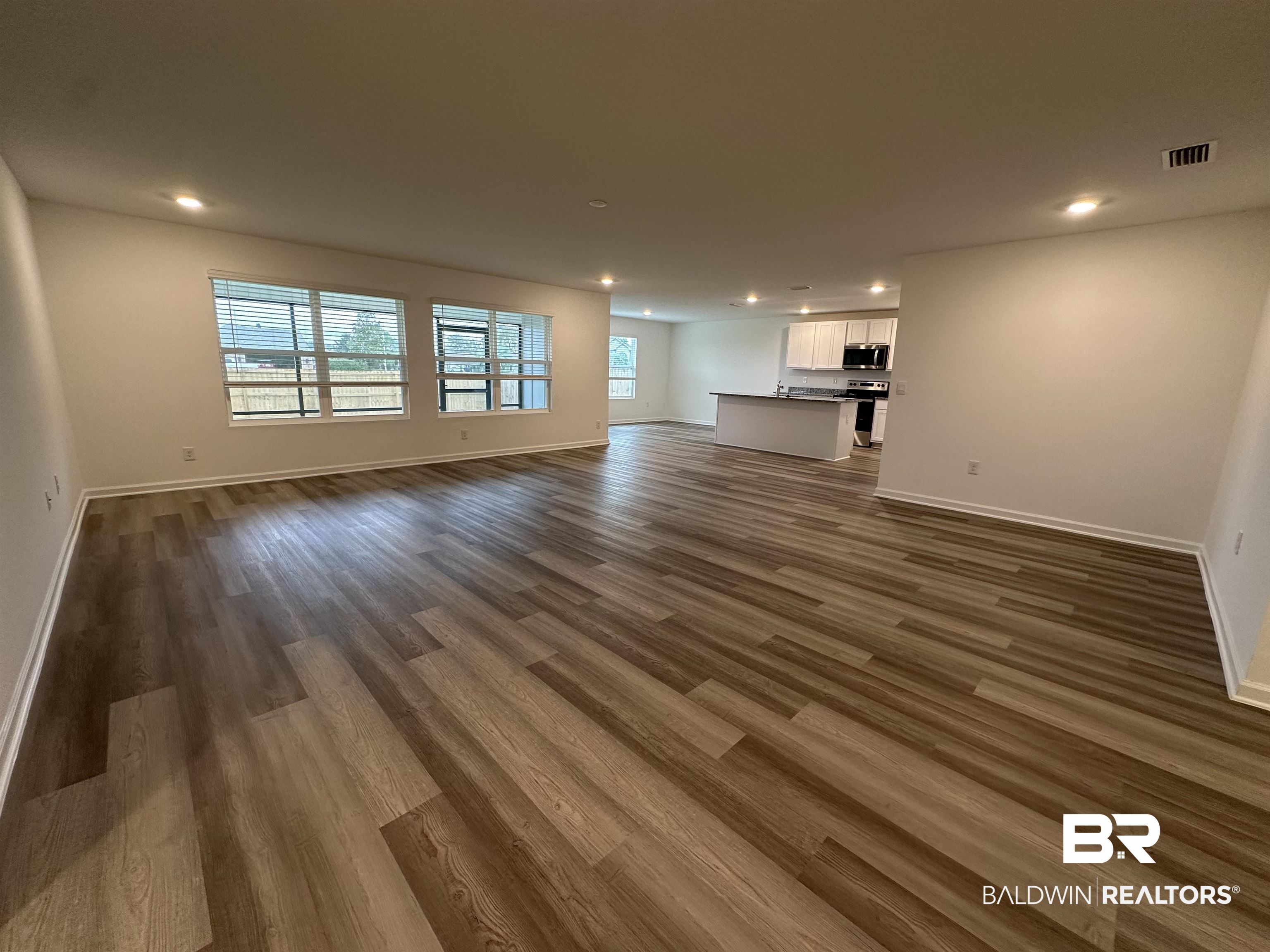 22275 Aleutian Avenue Foley, AL 36535 - Photo 10 of 72 Unfurnished living room with dark hardwood / wood-style flooring