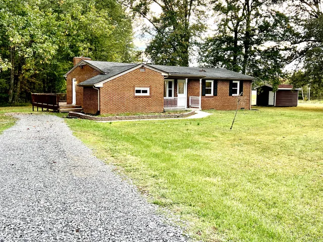 a front view of house with yard and trees