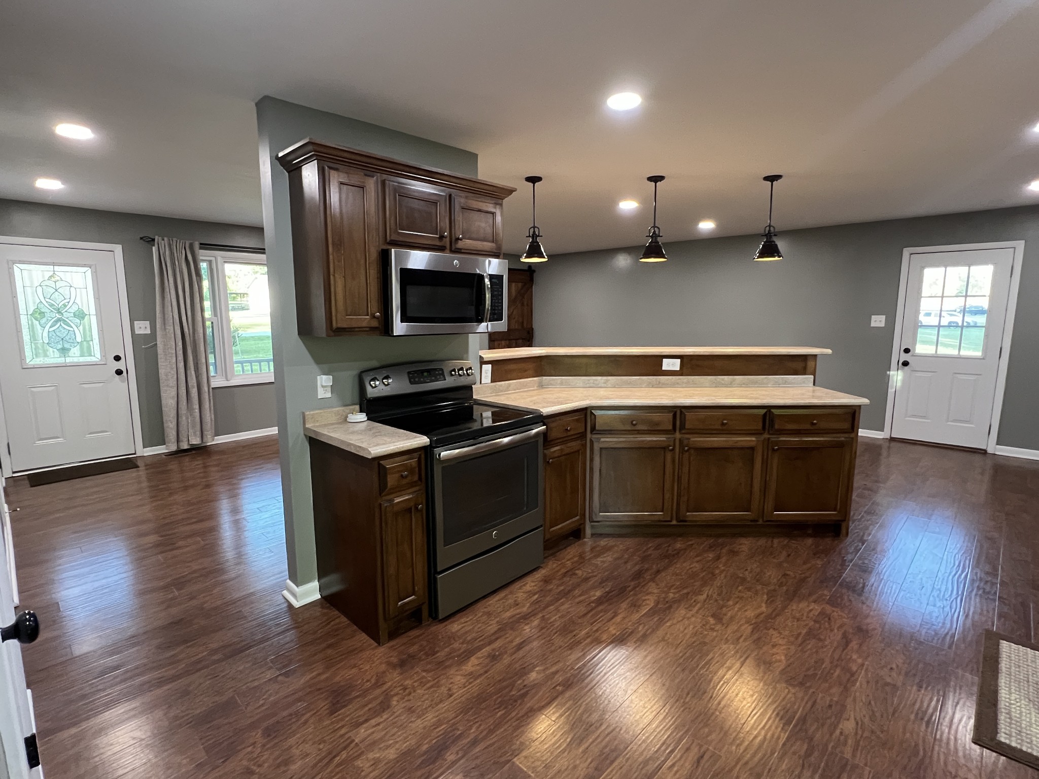 3019 Friendship Road Cross Plains, TN 37049 - Photo 12 of 39 a kitchen with stainless steel appliances kitchen island wooden cabinets and a wooden floor