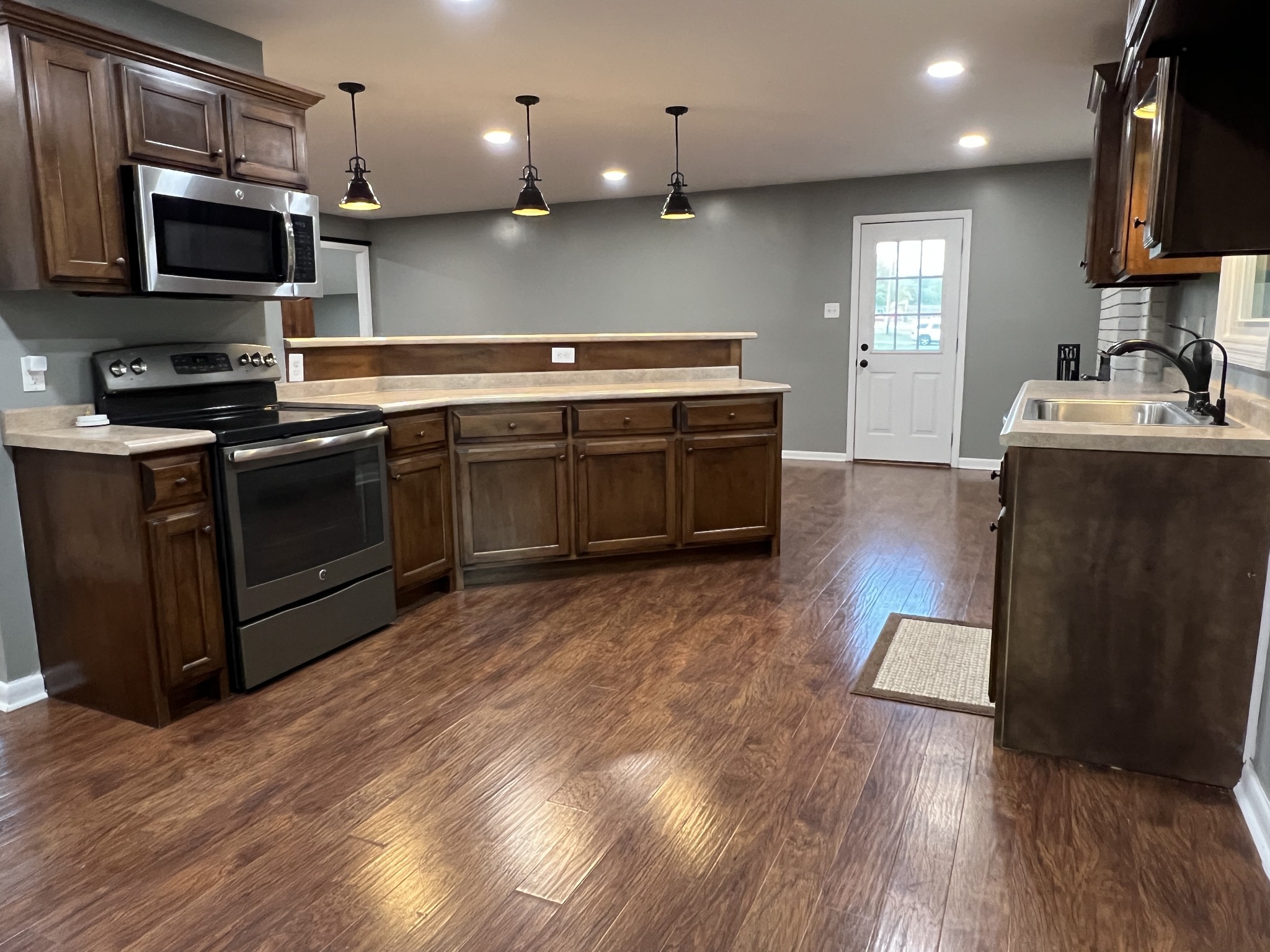 3019 Friendship Road Cross Plains, TN 37049 - Photo 13 of 39 a kitchen with stainless steel appliances a stove a sink and a microwave