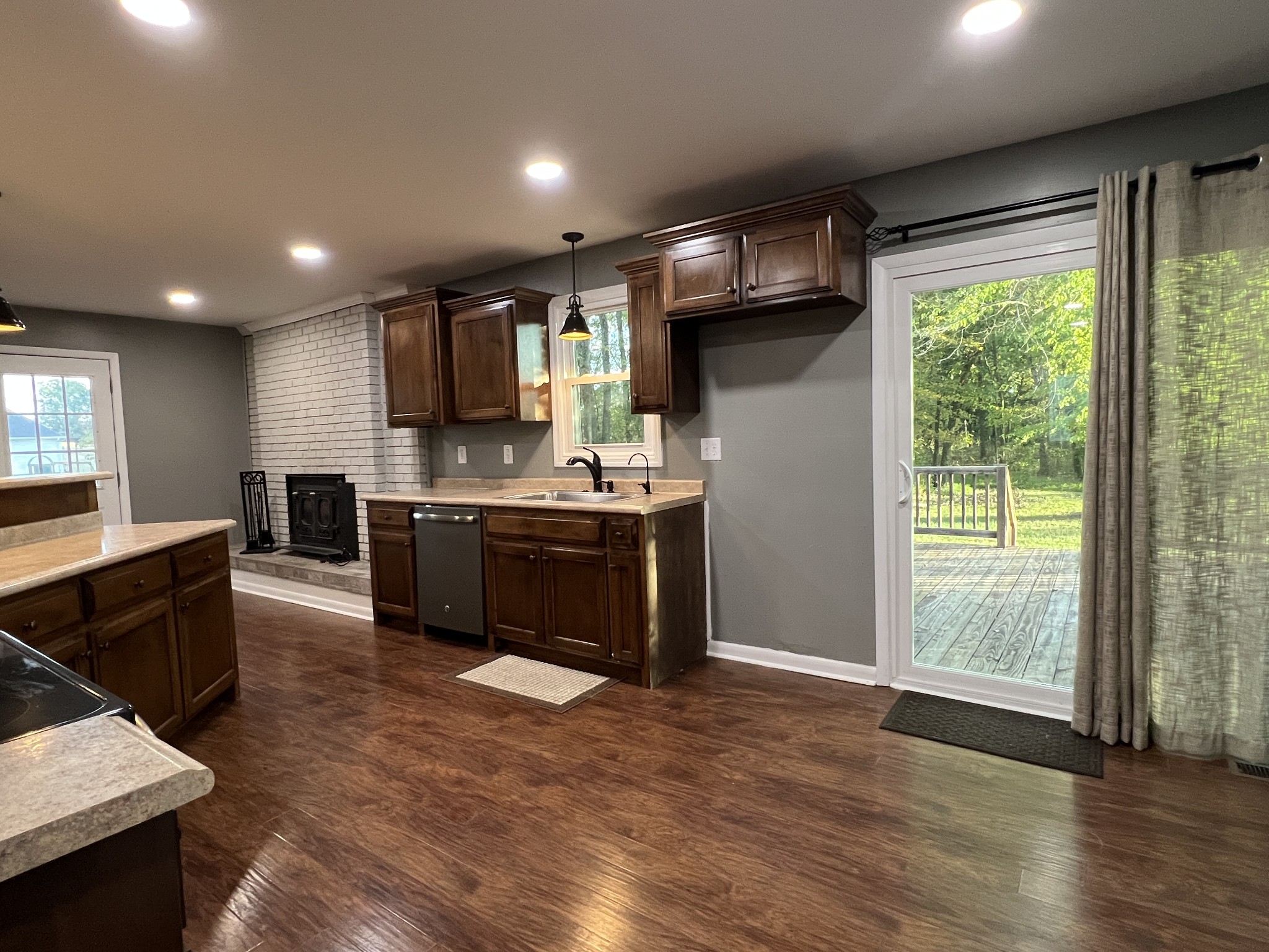 3019 Friendship Road Cross Plains, TN 37049 - Photo 9 of 39 a kitchen with stainless steel appliances granite countertop a refrigerator a sink a stove a microwave and island with wooden floor