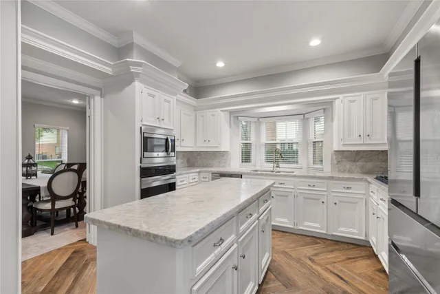 a kitchen with granite countertop a sink stove and cabinets