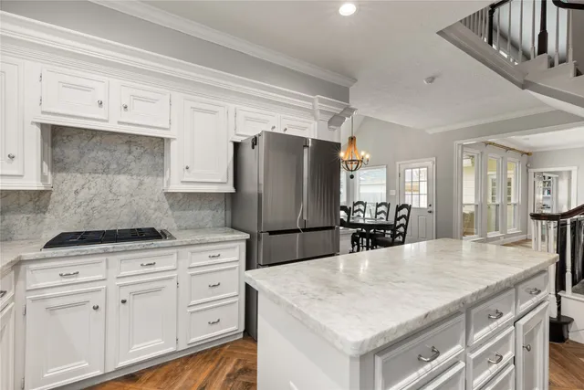 a kitchen with cabinets and stainless steel appliances