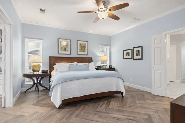 a bedroom with a bed and a chandelier
