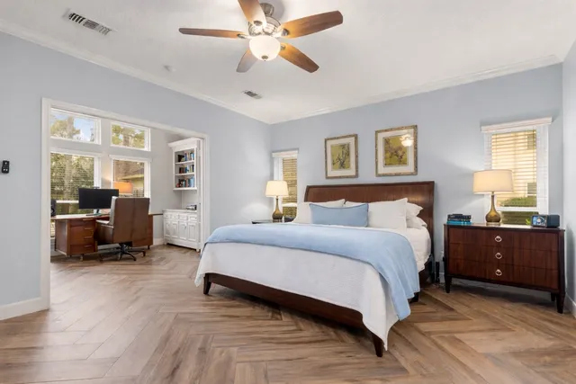 a spacious bedroom with a bed couch and a window