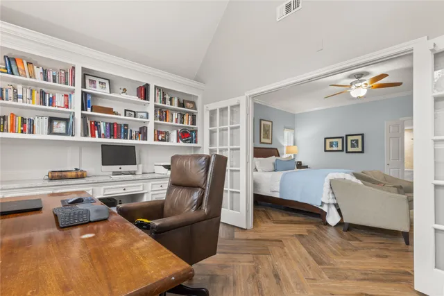 a living room with furniture and a book shelf