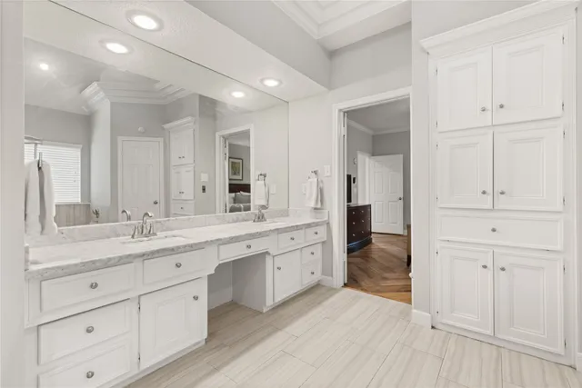 a spacious bathroom with a granite countertop sink and a mirror