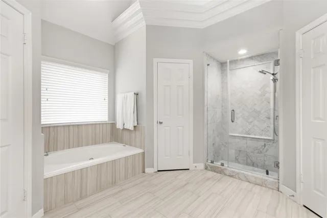 a bathroom with a tub shower and window