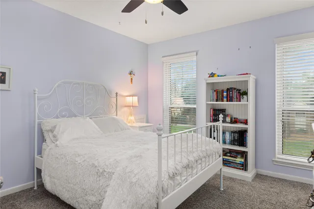 a bed sitting in a bedroom next to a window