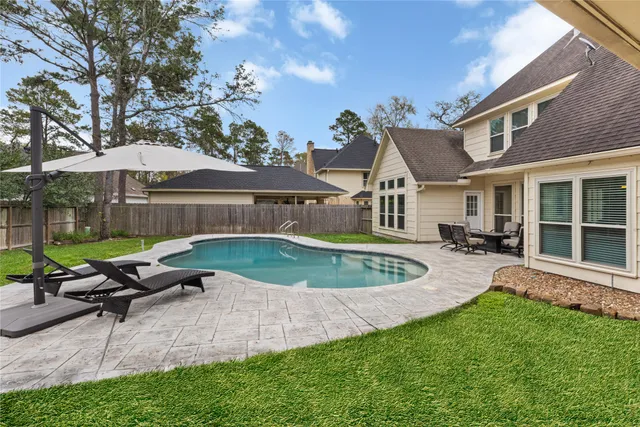 a view of a house with backyard porch and sitting area