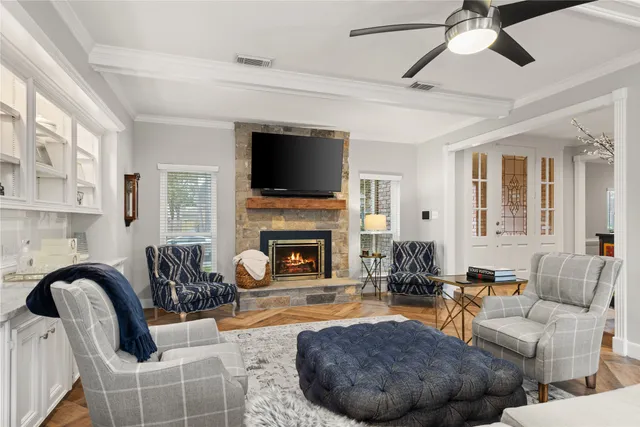 a living room with furniture a fireplace and a flat screen tv